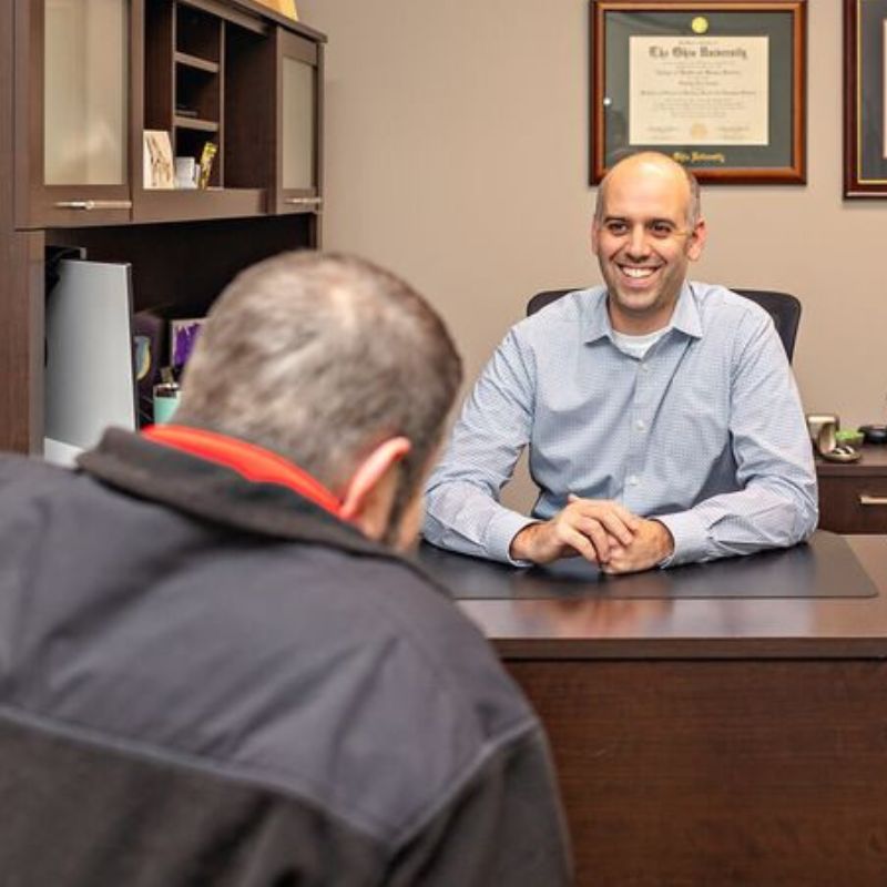 audiologist talking to a patient
